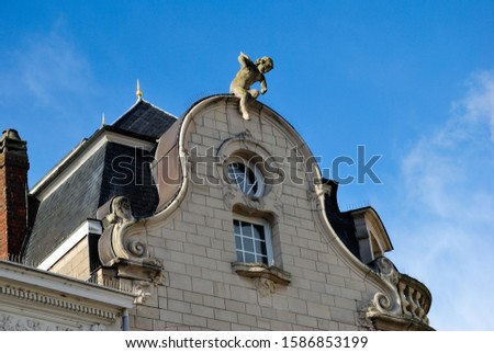 Stone baby angel on the roof of the medieval building in Lier, Belgium