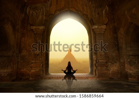 Woman with yoga pose in buddhist temple Royalty-Free Stock Photo #1586859664