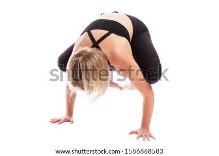 Young woman in black sportswear in yoga pose. Healthy lifestyle. Isolated over white background.