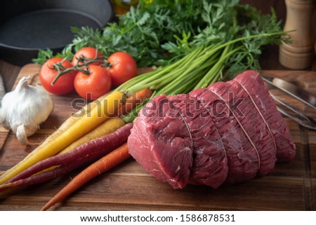 tied top round beef for roast beef with vegetable