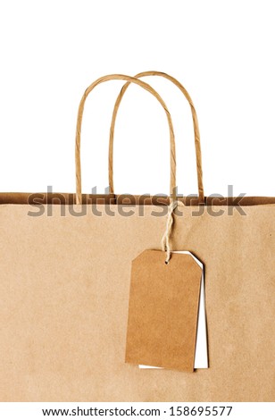 Paper shopping bag with blank tags isolated on white background