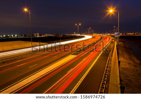 Busy rush hour traffic leaves light trails of red taillights on the A9 highway near Amsterdam, Schiphol to Haarlem.
