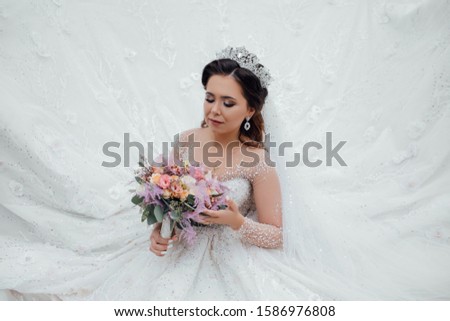 Wedding bouquet in the hands of the bride. Bride with wedding makeup and hairstyle. Wedding day. Gorgeous bride. Marriage. Woman, fashion, elegant fashionable lady, vogue style female
