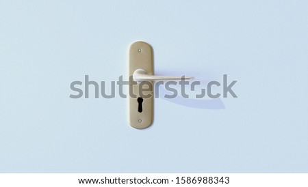Worn brass door handle on a white wood surface, with a keyhole