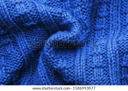 Knitted Sweater Background Twisted into a Spiral. Navy blue pattern. Facial surface. Copy space