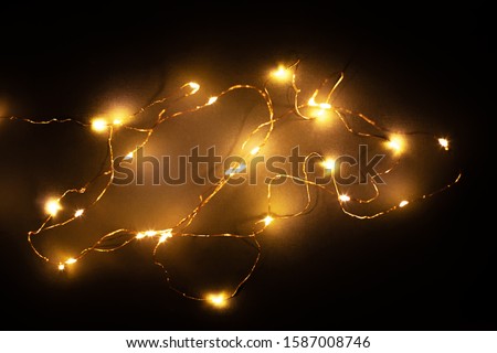 Abstract christmas led lights on black background. Blurred glowing light bulb garland, black layer for screen mode overlays to light up the bulbs. Festive concept Royalty-Free Stock Photo #1587008746