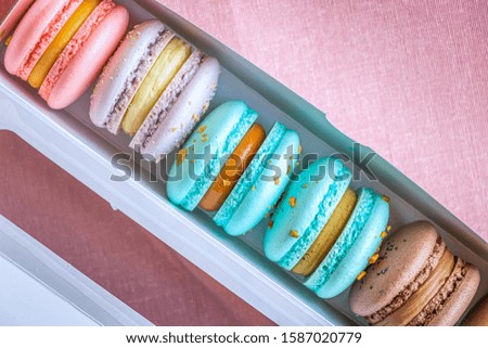 Macarons with cream in a box. Close up and top view.