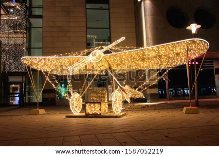 An airplane-shaped illuminated Christmas sculpture in the street in Magdeburg, Germany at night