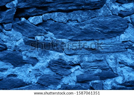 Classic blue color concrete wall stone brick texture background. Concept color of the year 2020