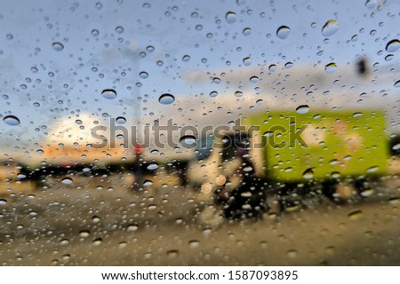 Road view through car window blurry with heavy rain, Driving in rain, rainy weather, rainy day, rain background