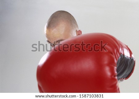 Male boxer throwing a punch, facing the camera