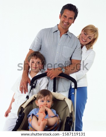 Family portrait, parents with two children, one in a stroller