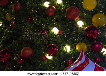Illuminated  decoration of  Christmas tree with  hanging yellow and red ball. Flat layout for Christmas festival background concept.