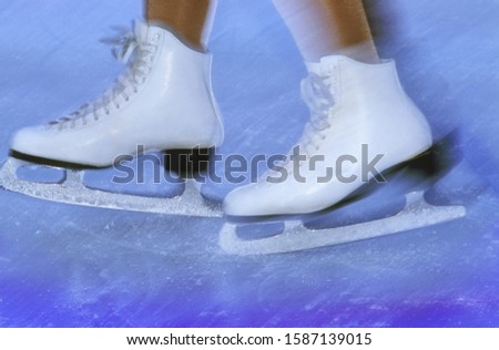Blurred view of a woman skating with white ice skates