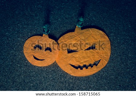 Halloween decoration. Pumpkin head cutouts on a notice board.