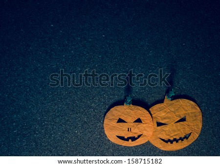 Halloween decoration. Pumpkin head cutouts on a notice board with copy space. 
