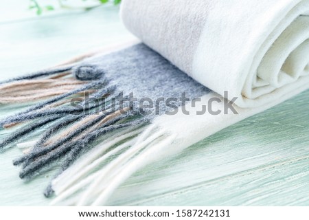Woolen scarf on wooden background