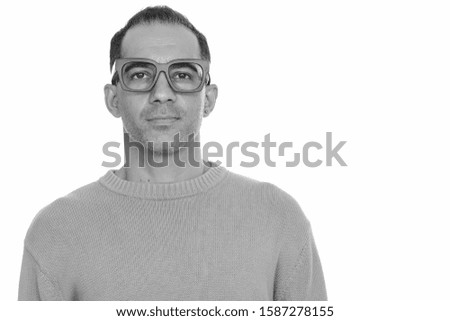 Mature handsome Persian man with eyeglasses in black and white