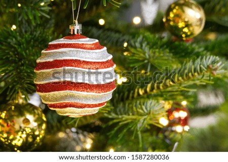 red ornament with Christmas tree on background, copy space for text