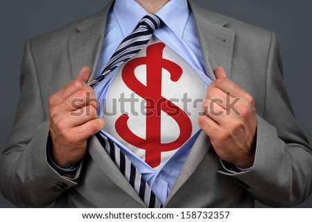 Businessman in classic superman pose tearing his shirt open to reveal a dollar symbol on chest concept for human financial advisor, success or recruitment