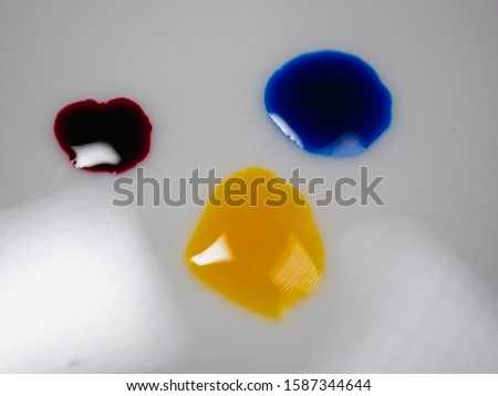 Three color drops on a white background