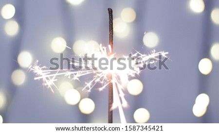 Close-up of firework sparkler burning. Fireworks burn on a blue background