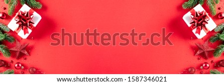 Christmas background concept. Top view of Christmas gift box red and golden ball with snowflakes on light red pastel background, ornament corner border frame header banner.