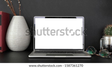 Cropped shot of professional designer workplace with blank screen laptop computer and office supplies 