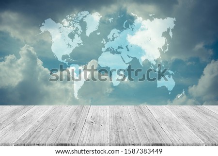 Cloudscape of natural sky with blue sky and white clouds in the sky use for wallpaper background with wood table or terrace and world map