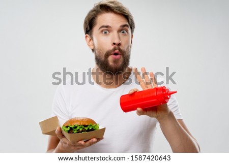 Ketchup man with a hamburger white t-shirt cropped view