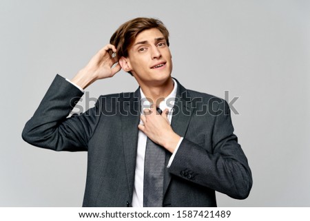 Man in a jacket shirt a gray background