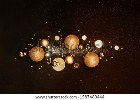 Christmas background. Festive composition of golden Christmas balls and decorations, shiny ornament, pattern. Concept festive backgrounds for promotions and sales. Flat Flat