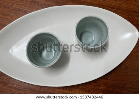Two teacups paired together in a white plate
