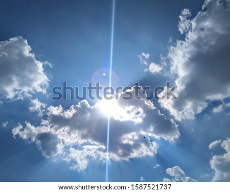sun slightly come out from abstract cloud and create sun flare.