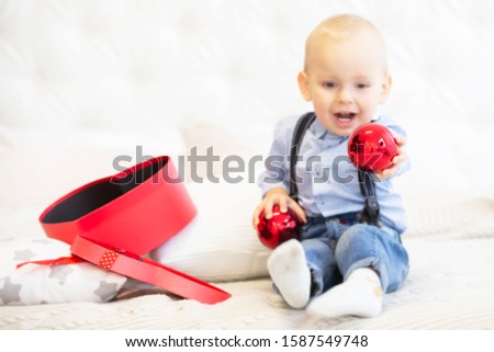 Blurred child holds a bright Christmas toy.
