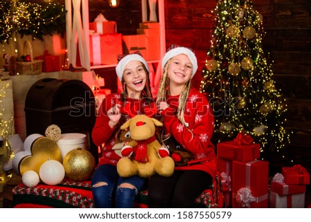 December holidays. Holidays and vacation. Happy holidays. Children having fun christmas eve. Happiness joy. Family values. Sisterhood concept. Girls friends sisters Santa claus costumes. Playful kids.