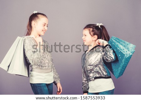 Black friday. Sale and discount. Shopping day. Children hold bunch packages. Kids fashion. Girls sisters friends with shopping bags violet background. Exciting place to shop. Shopping and purchase.
