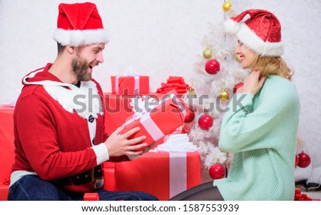 Couple in love enjoy christmas holiday celebration. Family prepared christmas surprise. Dreams come true. Opening christmas present. Loving couple smiling unpacking gift christmas tree background.