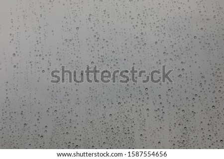 Background image of raindrops on transparent glass