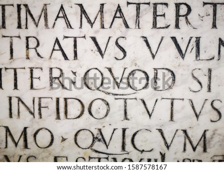 Texture of letters. Roman font. Carving on marble. Lettering background.