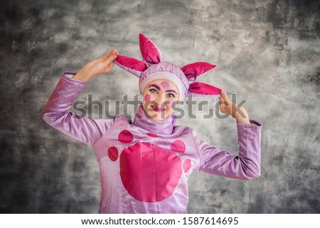 Man dressed as a cartoon character isolated on grey background. Growth doll. Mascot. Fancy dress, carnival, fancy dress animator, a party, masquerade.