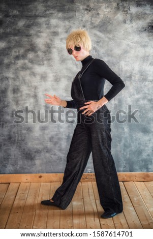 
Actor in the costume of detective closeup, in a black suit and dark glasses, isolated on a gray background. Poster. Live emotions, theatrical behind the scenes. Fancy dress, party, masquerade.