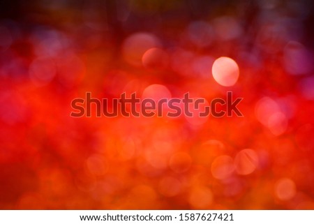 Abstract background The distribution of white bokeh on a reddish orange background. Trend color 2020