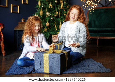 Children open gifts boxes. Concept of Merry Christmas, vacation, holidays and family.