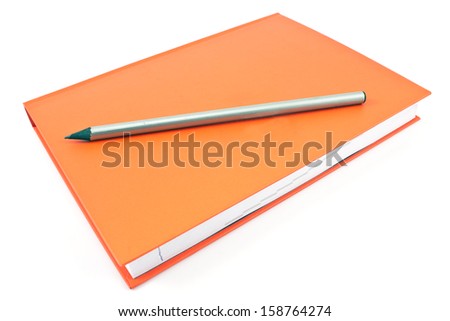 Wooden pencil on red  notebook isolated  on white