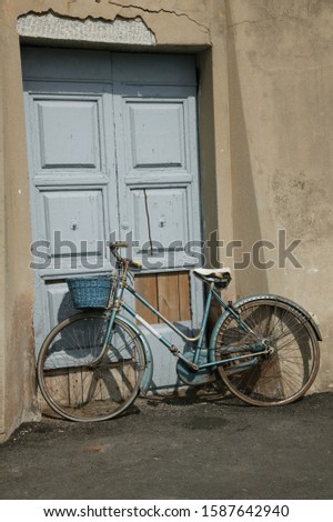 Bicycle leaning against a door, Elba, Tuscany, Italy