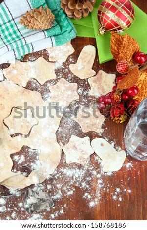 Making Christmas cookies on wooden table