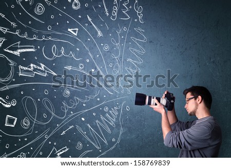 Photographer boy shooting images while energetic hand drawn lines and doodles come out of the camera