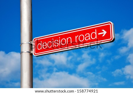 Decision road direction sign, cloudy sky in the background.