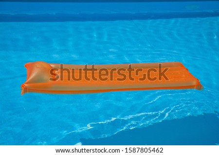 Inflatable colored mattress in the pool